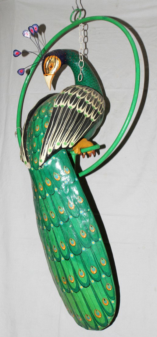 SERGIO BUSTAMANTE ACRYLIC & PAPIER SCULPTURE,: SERGIO BUSTAMANTE (MEXICAN, 20TH CENTURY), ACRYLIC & PAPIER MACHE SCULPTURE, 1979, 50" X 12", 'PAVO':Polychrome papier mache figure of a peacock is depicted perched on a painted metal ring. Signed and