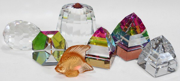 SWAROVSKI & OTHER CRYSTAL PAPERWEIGHTS: SWAROVSKI & OTHER CRYSTAL PAPERWEIGHTS IN RAINBOW COLORS, 6, ALSO LALIQUE FISH, 7 PIECES TOTAL:Paperweights are in cut layers and in pyramid and egg shapes, 1 3/4", 2 1/2", 3", 2", etc. Lalique fish i