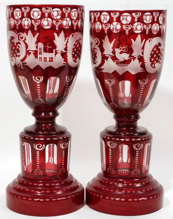 BOHEMIAN CRYSTAL VASES, CRANBERRY TO CLEAR,: BOHEMIAN CRYSTAL VASES, CRANBERRY TO CLEAR, PAIR, H 12", DIA 5":Having scenes depicting a church, deer and flowers.
