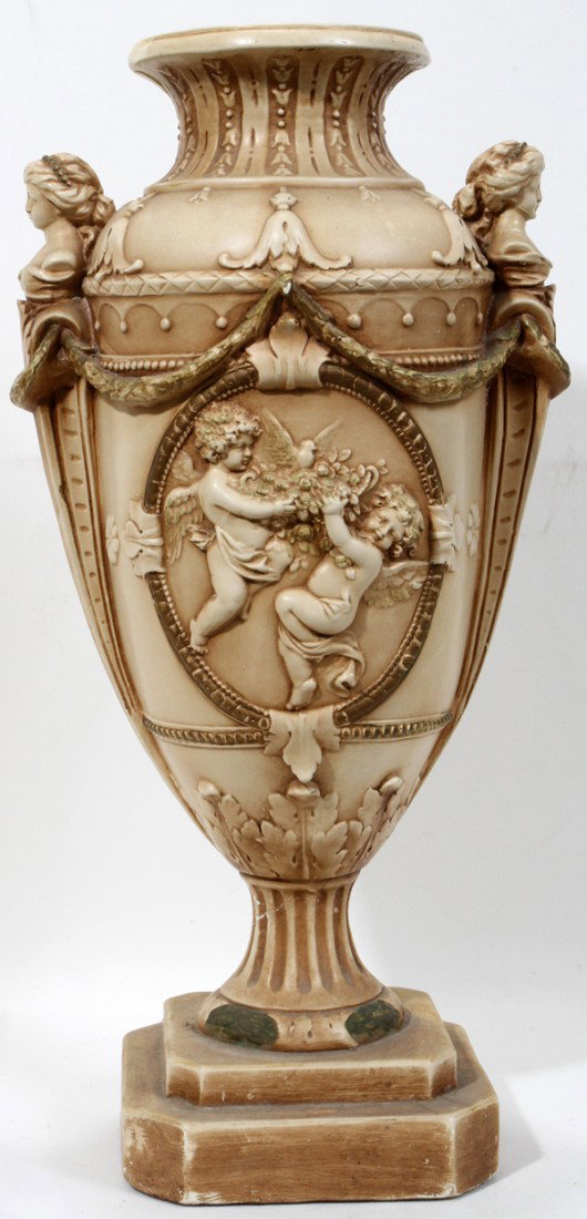 MARWAL IND INC PLASTER URN, MID 20TH CENTURY,: MARWAL IND INC PLASTER URN, MID 20TH CENTURY, H 21", W 10", AS IS:Having Neoclassical motifs include busts at either side, putti, and swags. Marked "Marwal Ind Inc" at the interior, near the rim.