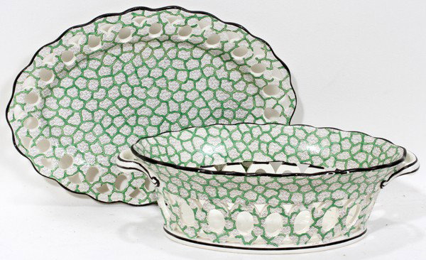 CREAMWARE RETICULATED BASKET ON STAND, L 9 1/4": ENGLISH STYLE CREAMWARE RETICULATED BASKET ON STAND, L 9 1/4":An oval basket flanked by handles, H.2 3/4", L.9", with a conforming stand, L.9 1/4"; each piece decorated with a green seaweed pattern ov