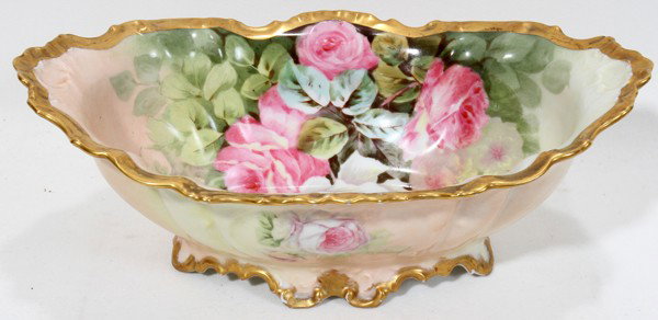 BAWO & DOTTER, LIMOGES PORCELAIN FOOTED BOWL, : BAWO & DOTTER, LIMOGES HAND-PAINTED PORCELAIN FOOTED BOWL, L 11":Featuring rose designs with gold accents. Signed L. Bart and marked on the underside Elite Works SM Limoges France. Measures H.3 3/8", 