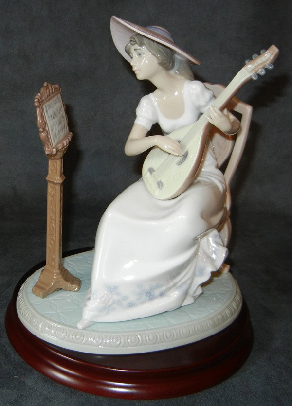 LLADRO PORCELAIN FIGURE 'SWEET SONG', H 8 1/4": LLADRO PORCELAIN FIGURE 'SWEET SONG', H 8 1/4":girl seated playing banjo, reading music on a stand. Does not include box