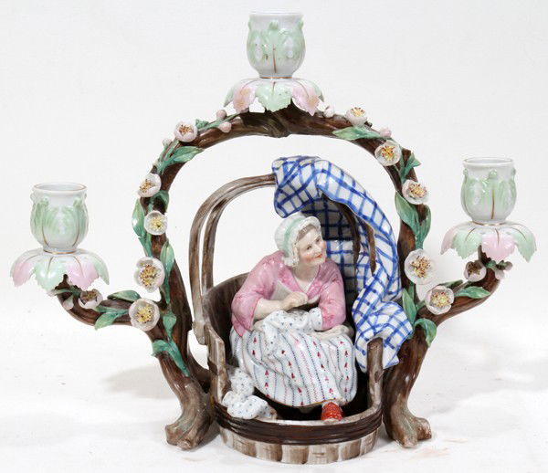 GERMAN PORCELAIN THREE-LIGHT CANDLEHOLDER,: GERMAN PORCELAIN THREE-LIGHT CANDLEHOLDER, H 10 1/2", W 13":Featuring a central figure of a female seated below a floral arch which support the three candle holders. Marked on underside JR.