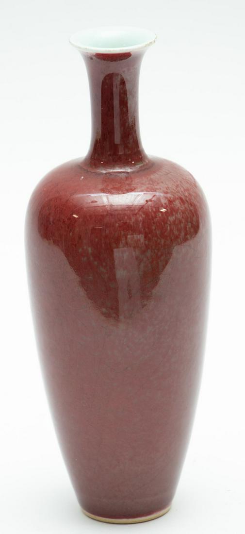 CHINESE SANG DE BOEUF PORCELAIN VASE, H 9", DIA 3.5": CHINESE SANG DE BOEUF PORCELAIN VASE, H 9", DIA 3.5" A Chinese sang de boeuf glaze porcelain vase. Bearing calligraphic marks to the underside under glaze.