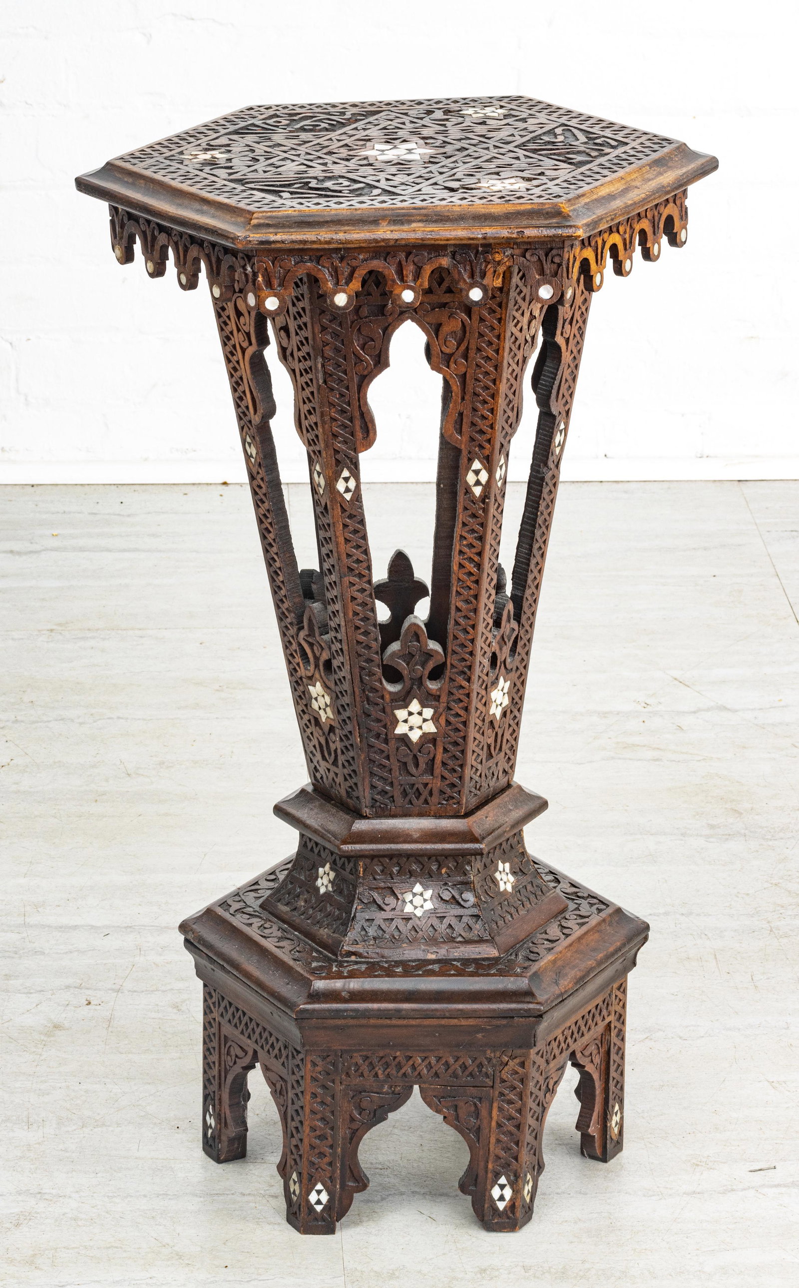 MOORISH CARVED WOOD, MOTHER OF PEARL INLAY PEDESTAL TABLE, H 26", DIA 15": MOORISH CARVED WOOD, MOTHER OF PEARL INLAY PEDESTAL TABLE, H 26", DIA 15" A Moorish carved wood pedestal table. Accented with mother of pearl inlay.