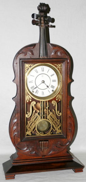 SETH THOMAS, WALNUT VIOLIN SHELF CLOCK: SETH THOMAS, AMERICAN WALNUT EIGHT-DAY VIOLIN SHELF CLOCK, 1881, H 29":Brass 8-day, spring-driven movement with strike. Including pendulum and key. #5881 L" STENCILED ON BACK OF CLOCK INDICATING THE Y