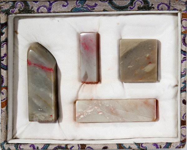 JAPANESE CARVED SOAPSTONE LETTER SEALS, FOUR: JAPANESE CARVED SOAPSTONE LETTER SEALS, FOUR, L 1" - 2":In a silk lined box.