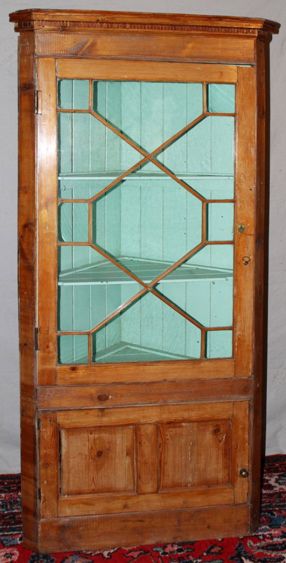 ENGLISH PINE CORNER CUPBOARD, 19TH C.: ENGLISH PINE CORNER CUPBOARD, 19TH C., H 75", D 25":Upper door inset with glass, enclosed base cabinet. Original backboard. Fenestrated glass. "Wembley" and "Mrs. Field, 107 Ealing Rd." written on bac