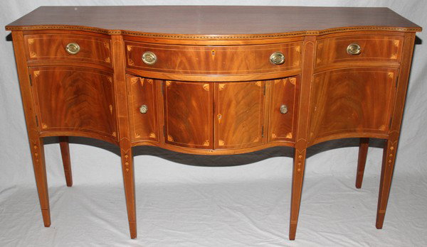 HEPPLEWHITE STYLE MAHOGANY SIDEBOARD, H 35": HEPPLEWHITE STYLE MAHOGANY SIDEBOARD, H 35", W 65", D 23":Satinwood string inlay and bellflower inlay. Has three drawers in frieze, two lower deep drawers and four doors. Circa 1940.