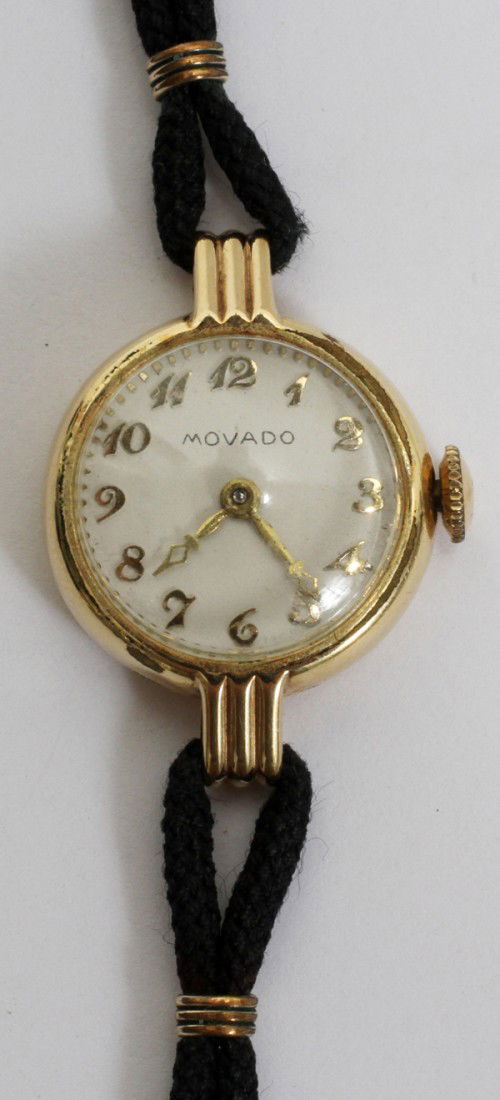 MOVADO LADY'S WRIST WATCH, 14KT GOLD FILLED: MOVADO LADY'S WRIST WATCH, 14KT GOLD FILLED:# 63 Monogram IED, black elastic band. From the Estate of Lloyd H. Diehl Jr.of Bloomfield Hills, Mi.