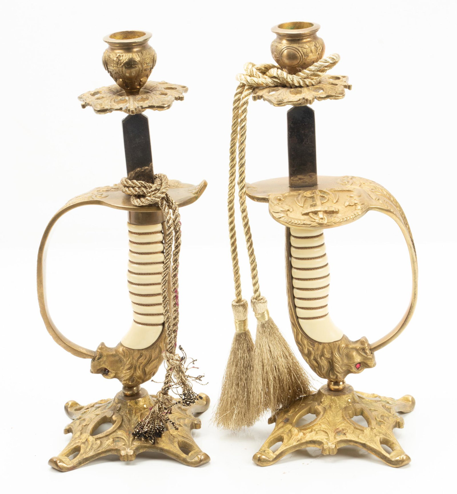 American Brass Naval Sword Hilt Candlesticks, Pair, H 10.5”, W 4”: AMERICAN BRASS NAVAL SWORD HILT CANDLESTICKS, PAIR, H 10.5", W 4" A pair of American naval sword hilts with lion's head pommels, converted to candlesticks. Provenance: Property of a Rochester Hills, M