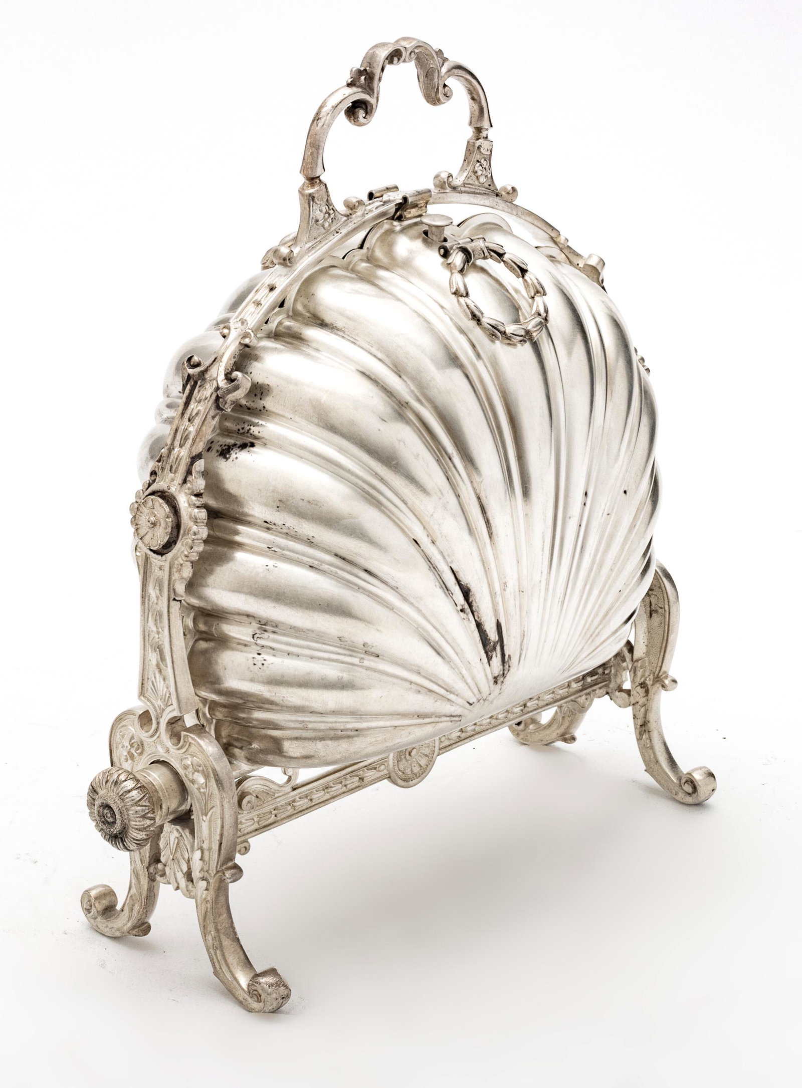 English Sheffield Plate Shell Form Folding Biscuit Box C 1900 H 11” W 9”: ENGLISH SHEFFIELD PLATE SHELL FORM FOLDING BISCUIT BOX C 1900 H 11" W 9" Hinged to open flat on frame with interior hinged covers. Elegant serving piece.