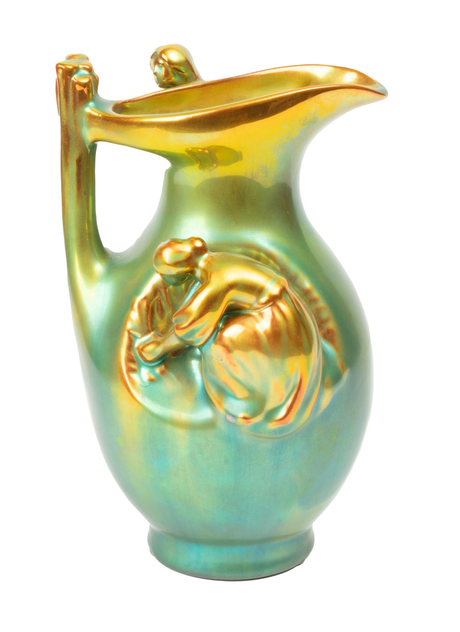 Zsolnay (Hungary) Pottery Ewer H 6’’: Zsolnay (Hungary) Pottery Ewer H 6'' Green/gold glaze. Signed. Figures of two women in full relief. Provenance: property of an Algonac, MI consignor.