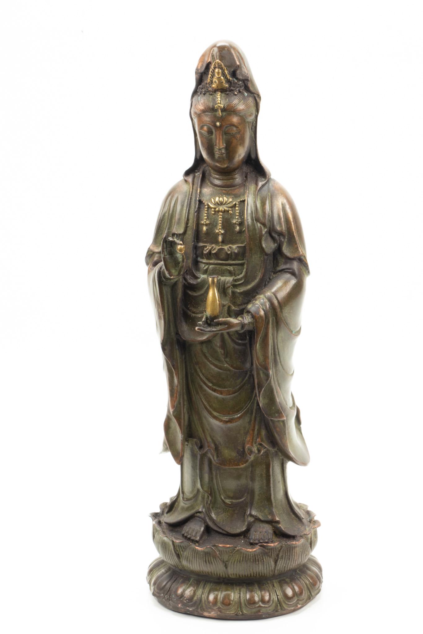 Chinese Bronze Figure, H 14.5”, W 5”, Quan Yin Standing on Lotus: CHINESE BRONZE FIGURE, H 14.5", W 5", QUAN YIN STANDING ON LOTUS A Chinese bronze figure depicting Quan Yin holding a vessel and standing atop lotus leaves. Artist's signature to the underside. Depth 