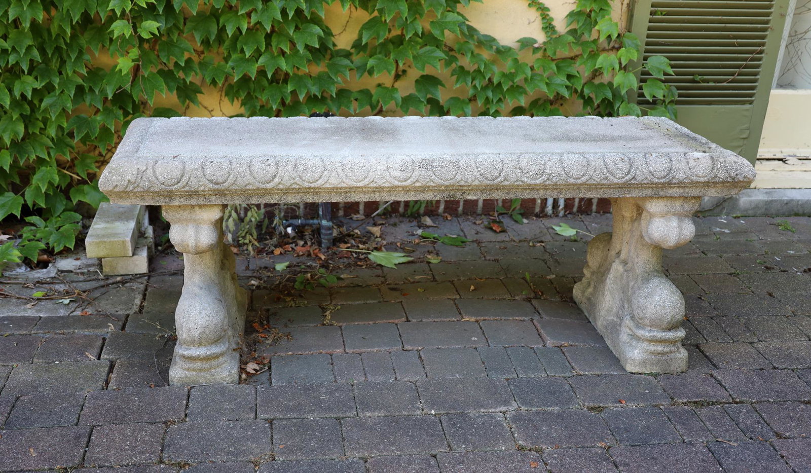 Cast Concrete Garden Bench, H 22’’ W 58’’ L 29.5’’: Cast Concrete Garden Bench, H 22'' W 58'' L 29.5'' Rectangular top with scalloped beveled edge and two dolphin formed supports. Late 20th c. cast. Provenance: Property of a prominent Central Avenue, B