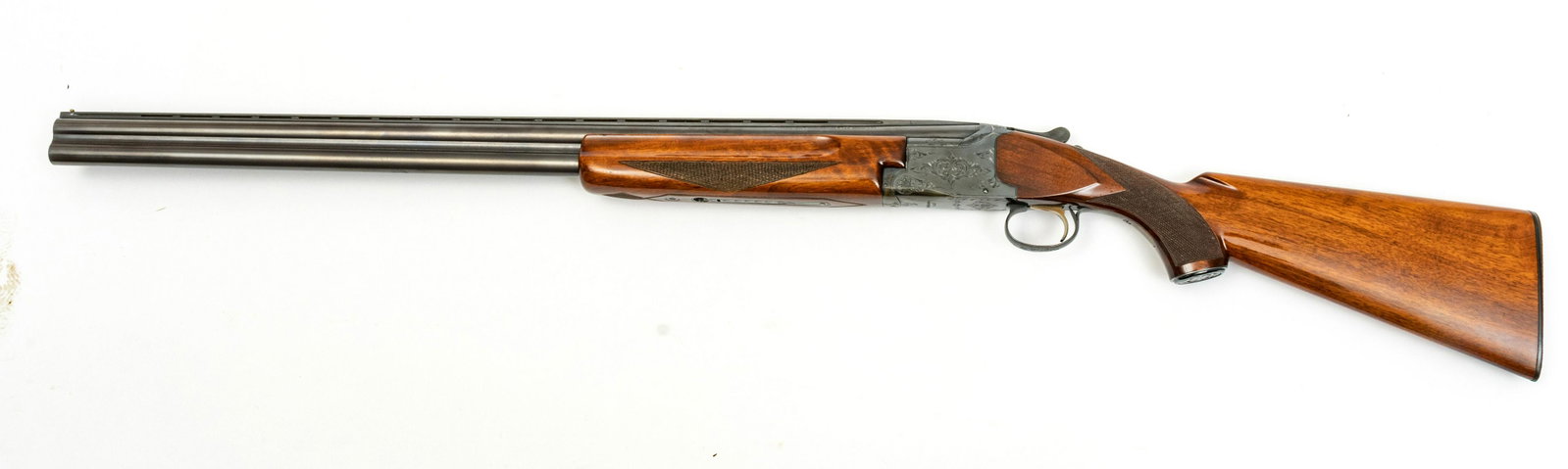 Winchester Model 101 Over-Under Shotgun, 12 GA., C. 1970S, L 30” Barrel, SN K142552: WINCHESTER MODEL 101 OVER-UNDER SHOTGUN, 12 GA., C. 1970S, L 30" BARREL, SN K142552 Gloss walnut stock and forearm. Having a scrolling leaf engraved receiver. Bead front sight. Barrel marked 'Model 10