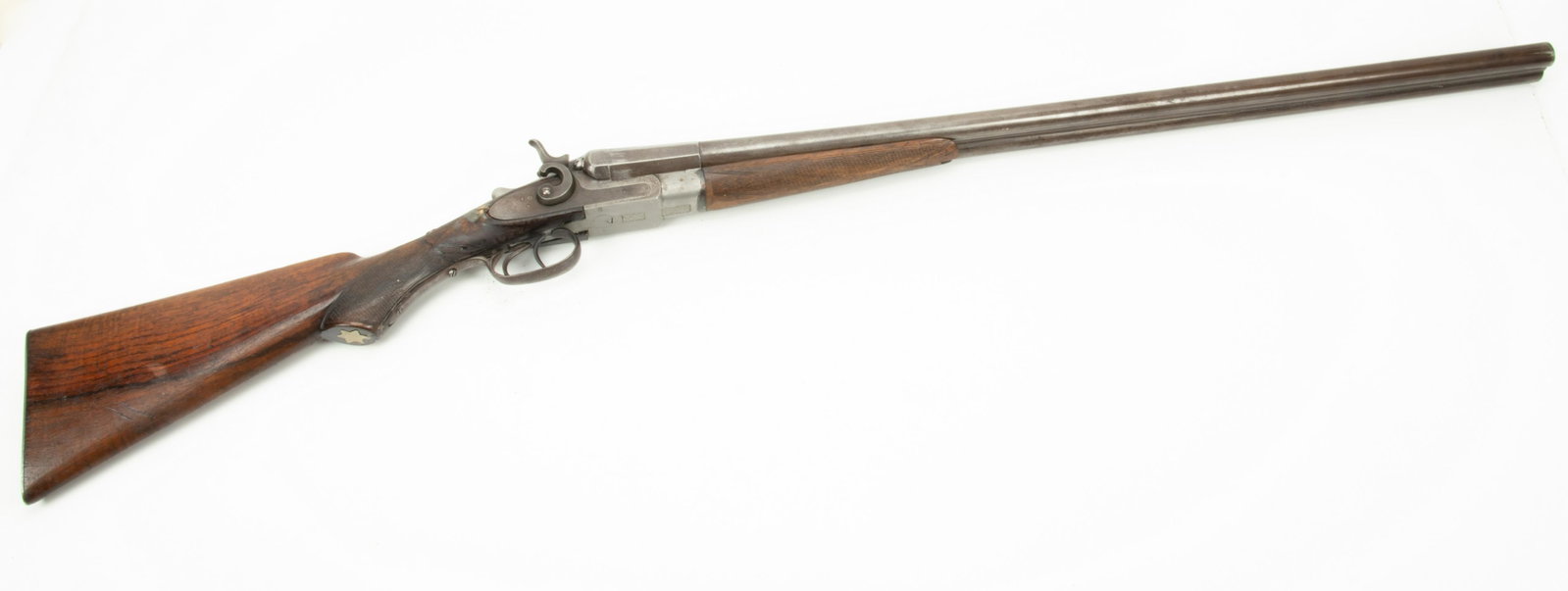 J. Reynolds Belgian Side by Side Double Barrel Shotgun, 12 GA., C. 1880S, L 29.75” Barrel: J. REYNOLDS BELGIAN SIDE BY SIDE DOUBLE BARREL SHOTGUN, 12 GA., C. 1880S, L 29.75" BARREL Walnut stock with checkered grip. Sawtooth engraved lockplates and external hammers. Tang mounted lever. Left 