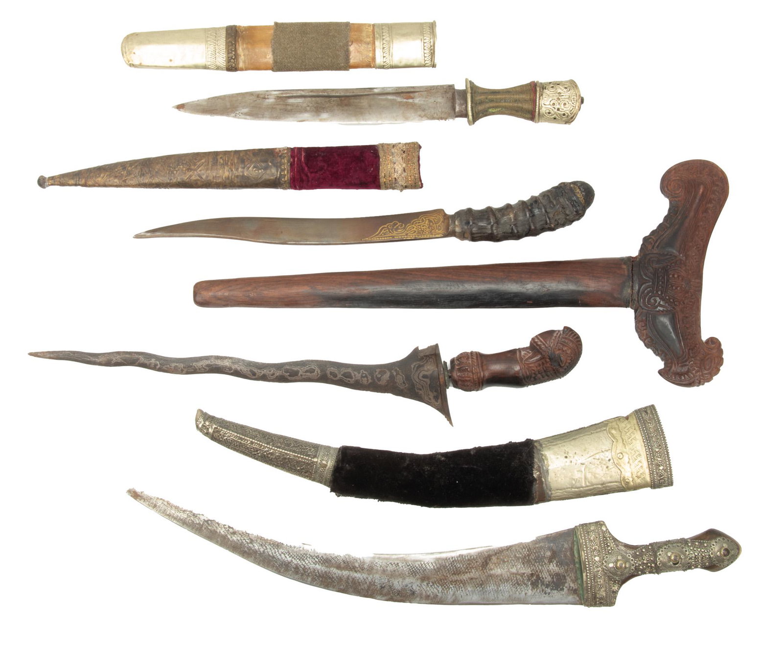 Daggars, Knives, Vintage Lot of Four Plus Sheaths: DAGGARS, KNIVES, VINTAGE LOT OF FOUR PLUS SHEATHS Top: silver Bhutanese knife. Hilt is wrapped wire with tooled silver cap. Blade sharp single edged. 11". Second from top: Carved Horn handle daggar fr