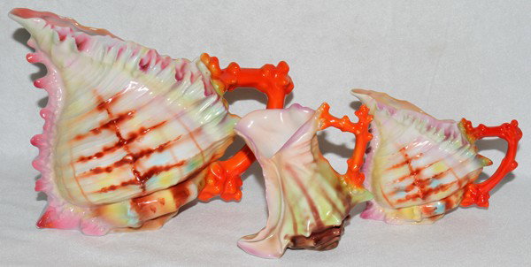 ROYAL BAYREUTH SHELL PORCELAIN PITCHERS, 3 PCS: ROYAL BAYREUTH SHELL PORCELAIN PITCHERS, THREE PIECES:Tallest H 6 1/2", L 8 1/2", unmarked. Smaller bulbous shaped pitcher H 4", L 5", unmarked. Boot shaped pitcher H 4 1/2, L 4", unmarked.