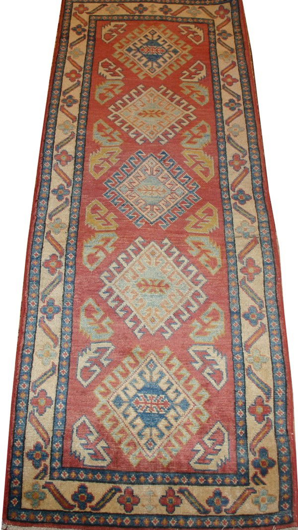 KAZAK PAKISTAN RUNNER, 6' 10" X 2' 4": KAZAK PAKISTAN RUNNER, 6' 10" X 2' 4":Red ground with four medallions and multiple borders.