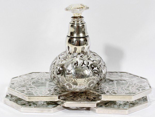 ART NOUVEAU STERLING OVERLAY PERFUME BOTTLE,: ART NOUVEAU STERLING OVERLAY PERFUME BOTTLE, H 4 1/2", & SET OF TRIVETS (5), W 4":Including 1 hand-blown glass perfume bottle with sterling silver overlay, engraved monogram and date 11-12-'94, H.4 1/