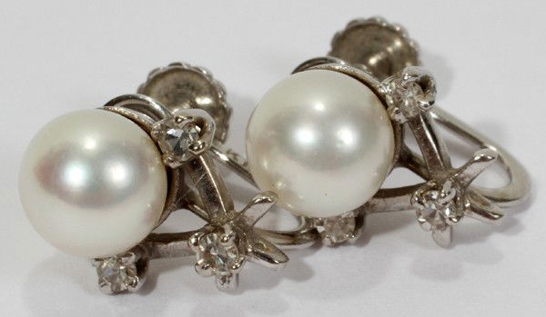WHITE GOLD SINGLE PEARL EARRINGS, DIAMOND: WHITE GOLD SINGLE PEARL EARRINGS, DIAMOND ENHANCED, PAIR:Stamped 14kt white gold. Three diamonds on each earring. Pearls approx 5mm. From the Estate of Gloria Vuici - Smith, Grosse Pointe, Mi.