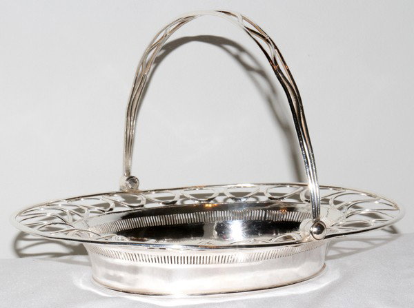 SILVER PLATE BASKET, W 9", L 11": SILVER PLATE BASKET, W 9", L 11":With a pierced rim that has a repetitive oval pattern. From the Collection of Bruce and Denise Wayne, Beverly Hills, Mi.