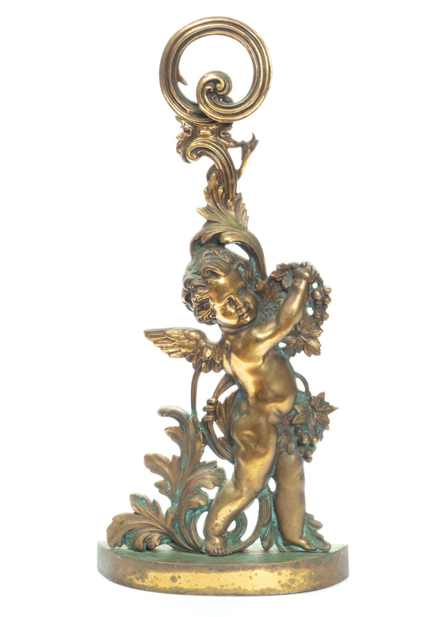 Brass Door Stop, Cupid Motif. C. 1900, H 19'': Brass Door Stop, Cupid Motif. C. 1900, H 19'' Very heavy. Scene of cupid is in relief.