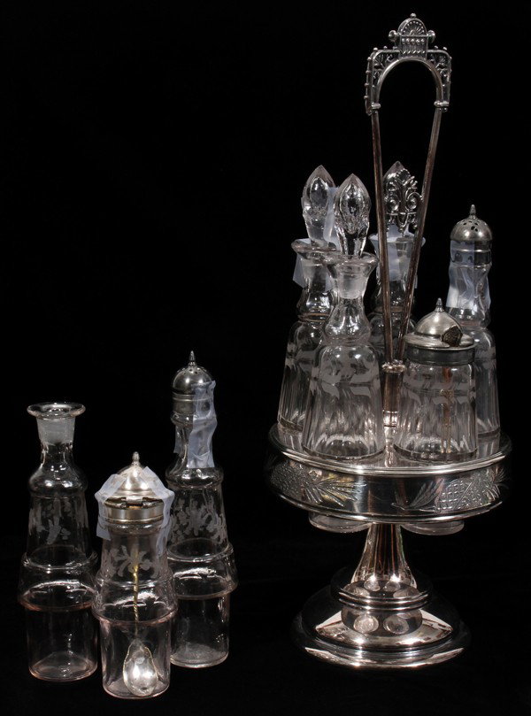 VICTORIAN SILVER PLATE & GLASS CASTER SET, : VICTORIAN SILVER PLATE & GLASS CASTER SET, C. 1870, H 16":Five matching bottles in revolving holder.Oil, vinegar, etc.