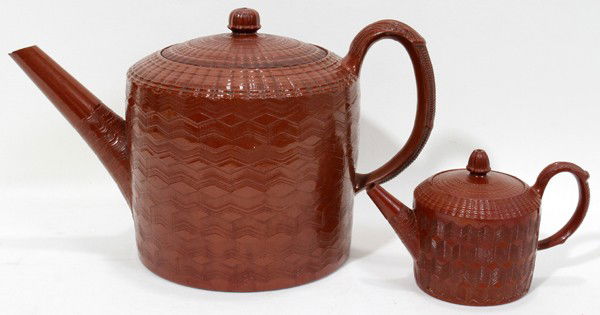 STAFFORDSHIRE GLAZED REDWARE TEAPOTS, C. 1770,: STAFFORDSHIRE GLAZED REDWARE TEAPOTS, C. 1770, TWO, H 4" & 8":Each of cylindrical shape with an engine turned wave pattern about; measuring H.4", W.6 1/4" and H.8", W.12 1/4".