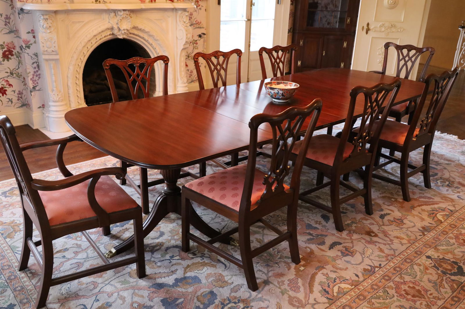 Henkel Harris Carved Mahogany Dining Table And 8 Chairs, H 29'' W 44'' L 68'': Henkel Harris Carved Mahogany Dining Table And 8 Chairs, H 29'' W 44'' L 68'' Having two carved pedestal bases with brass paw feet, and four leaves each 12". 6 side chairs and 2 arm chairs.