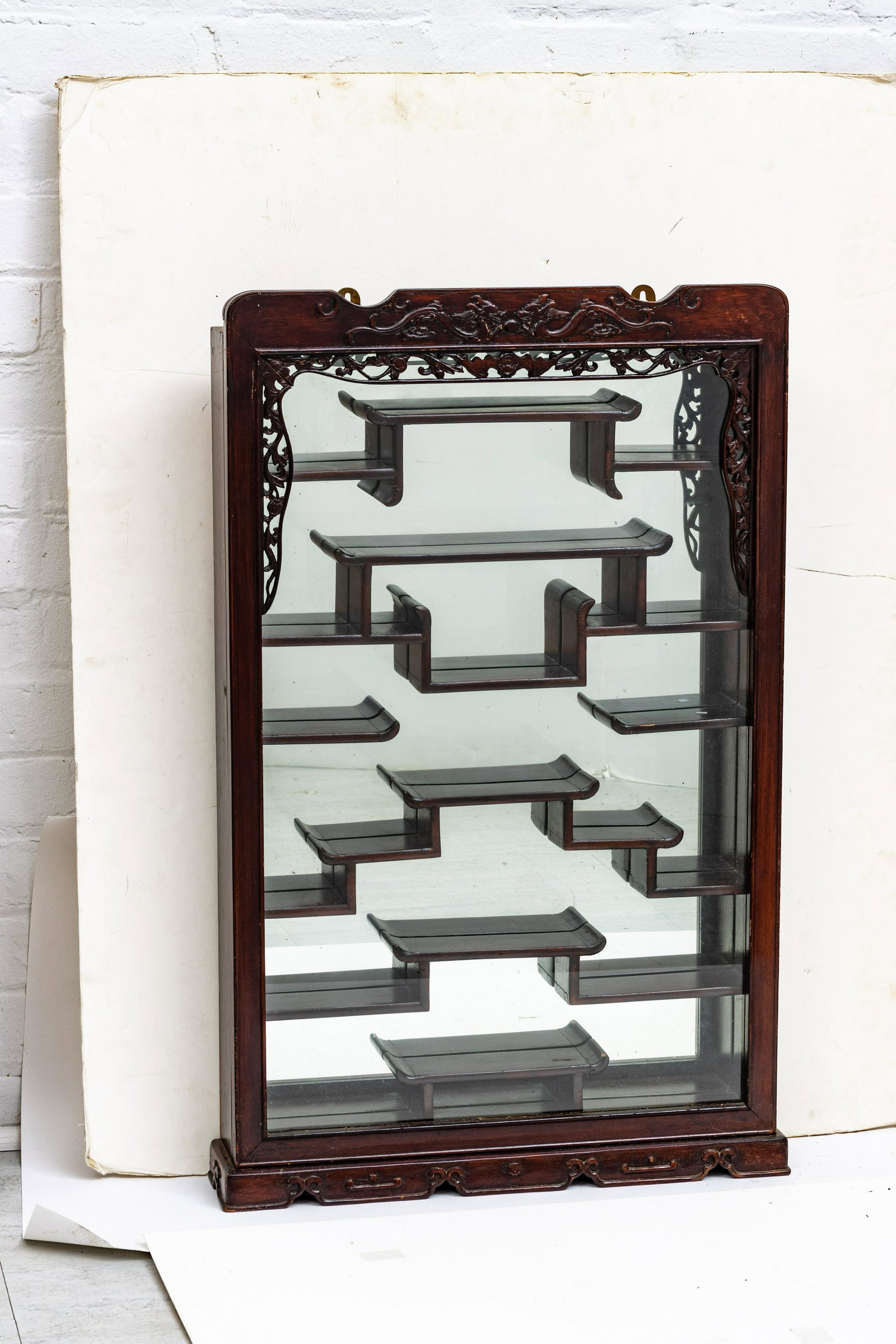 Japanese Wood Wall Mounted Curio Netsuke Cabinet H 33'' W 20'': Japanese Wood Wall Mounted Curio Netsuke Cabinet H 33'' W 20'' Five staggered shelves, mirror back.