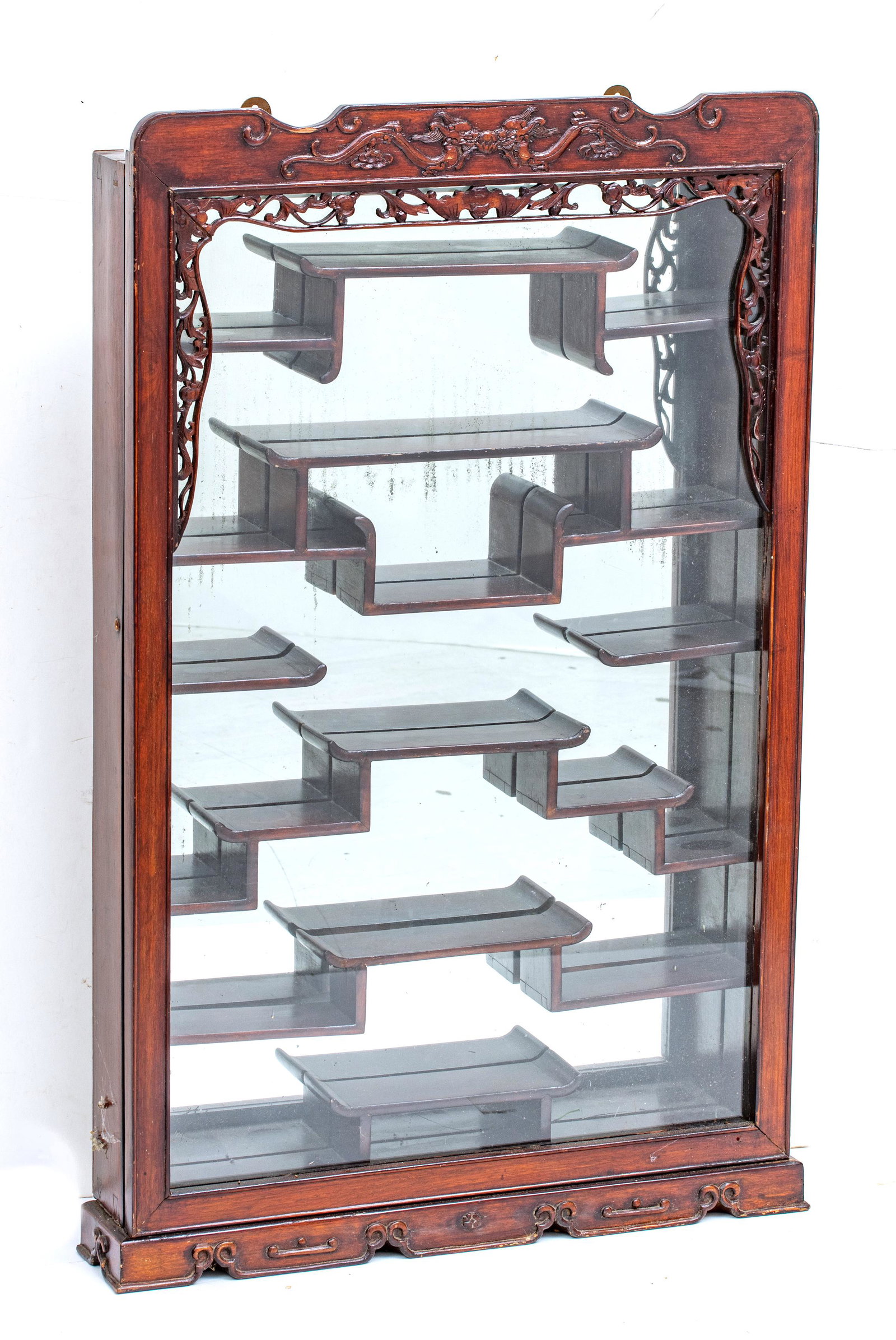 Japanese Netsuke Curio Cabinet, Teakwood H 33'' W 20'': Japanese Netsuke Curio Cabinet, Teakwood H 33'' W 20'' Mirror back, staggered shelves. Hinged glass inset door. Wall style