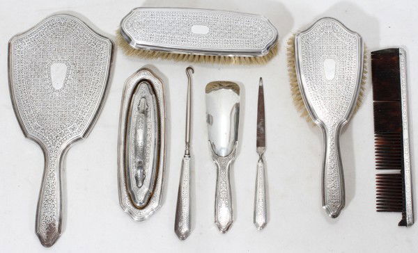 TIFFANY & CO. STERLING DRESSER SET, C. 1920: TIFFANY & CO. STERLING DRESSER SET, C. 1920, EIGHT PIECES:Including 1 hand mirror, L.10 1/2", 1 shoe horn, 1 nail buffer on 1 separate tray, 1 clothes brush, 1 nail file (rusted), 1 hair brush, 1 butt