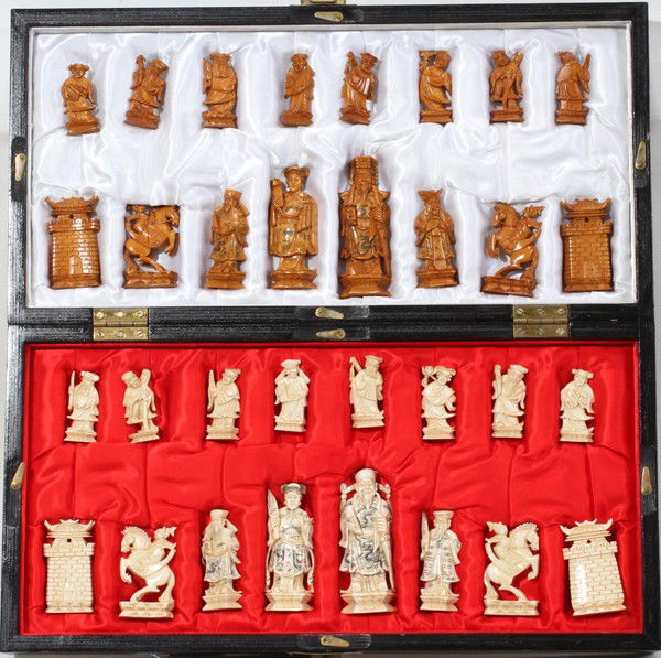 CHINESE CARVED IVORY CHESS SET & BOARD: CHINESE CARVED IVORY CHESS SET, 32 PIECES & BOARD:Includes 32 pieces, h 2" to 2 1/2" in figures, horse and pagoda carved pieces. The box transforms to a chess board.