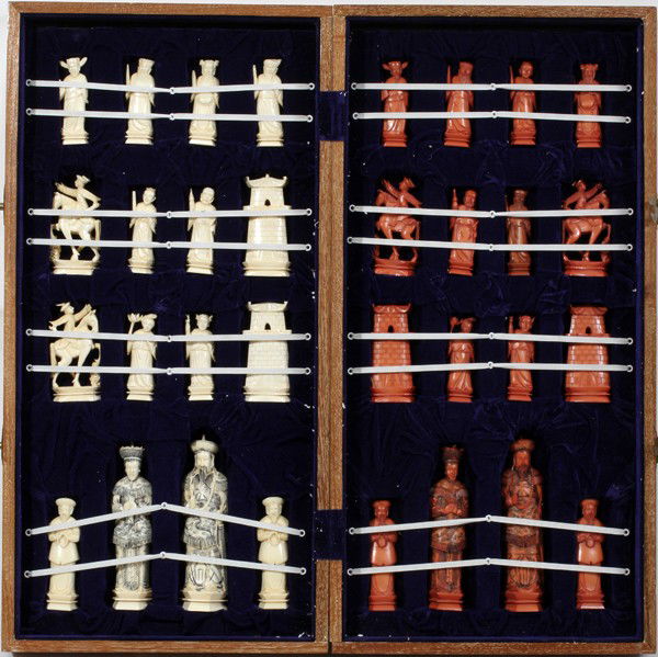 CHINESE CARVED IVORY CHESS SET & BOARD: CHINESE CARVED IVORY CHESS SET, 32 PIECES & BOARD, ONE OF THREE SETS IN SALE:Includes 32 pieces, h 3 1/2" to 7", in ivory color with figures, horses and pagoda as pieces. The box transforms into a boa