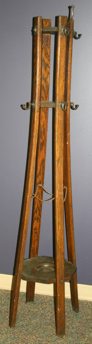 OAK AND CAST METAL COAT RACK C1900: OAK AND CAST METAL COAT RACK C1900, H 67", W 13", L 13":having a framework consisting of four vertical bent oak slats which form the rack with four metal chains suspended between the slats half way do