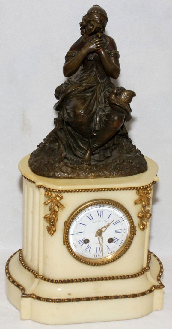 FRENCH BRONZE & MARBLE FIGURAL CLOCK: FRENCH BRONZE & MARBLE FIGURAL CLOCK, RAINGO FRERES, C. 1870, H 18", W 9 1/2":A white marble case centered by a circular dial, surmounted by a bronze figure of a young woman holding a dove. No pendulu