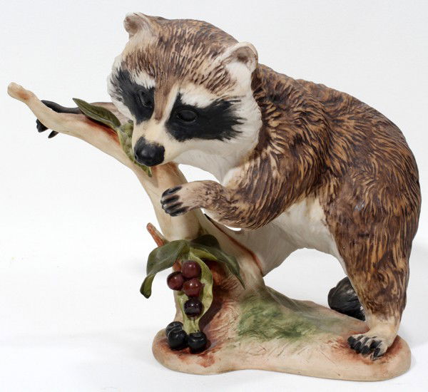 CYBIS BISQUE FIGURE OF A RACCOON, H 7 1/4": CYBIS BISQUE FIGURE OF A RACCOON, H 7 1/4":Depicts a raccoon at cherry tree slump.