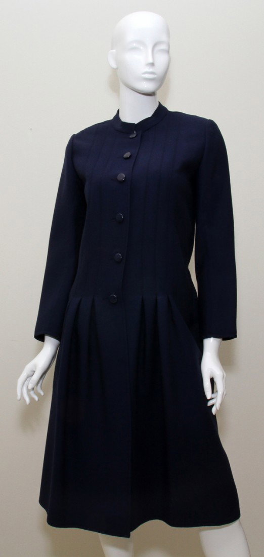 GIVENCHY NOUVELLE BOUTIQUE NAVY WOOL COAT: GIVENCHY NOUVELLE BOUTIQUE NAVY WOOL COAT:With six buttons, slit pockets. Size 40, shoulder to hem is approximately 43", made in France.
