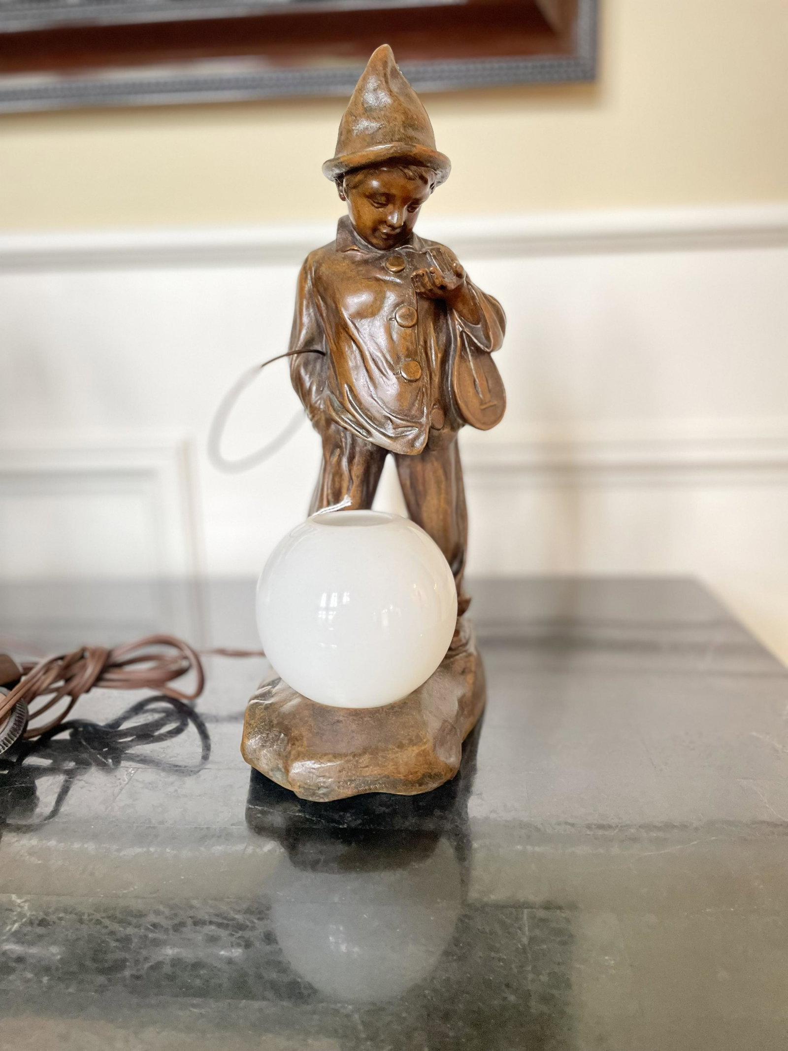 After Moreau Patinated Metal Light, Clown With Hoop C 1990 H 12": After Moreau Patinated Metal Light, Clown With Hoop C 1990 H 12" Electric Light. Glass Globe. Cast In France.From Pebble Beach, Rochester Hills, Mich.