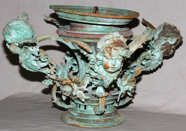 BRONZE LIGHT FIXTURE, H 14", DIA 23": BRONZE LIGHT FIXTURE, H 14", DIA 23":Green patina. With four winged cherubs. Originally had glass globe.