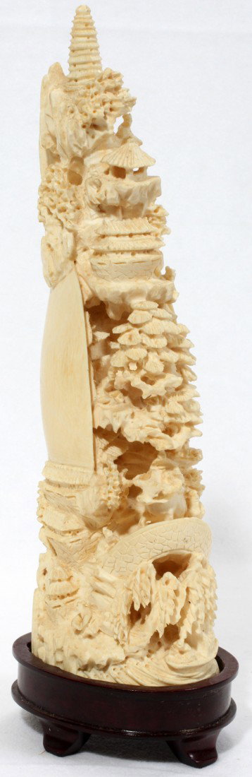 CHINESE CARVED IVORY MOUNTAIN, H 8": CHINESE CARVED IVORY MOUNTAIN, H 8":Carved as a mountainous village with pagodas, pine trees, and figures; signed (see additional photo).