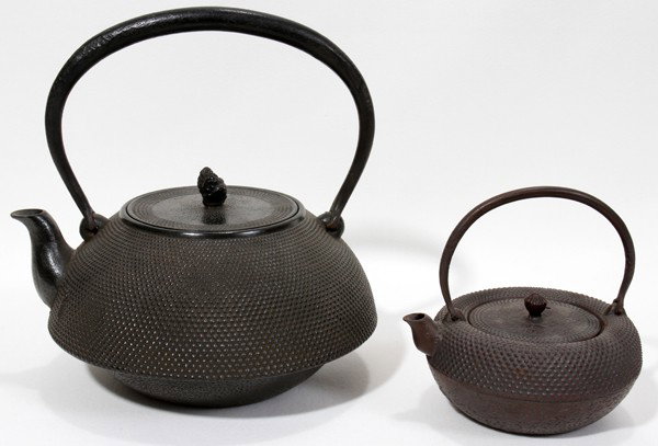 JAPANESE IRON TEAPOTS, EARLY 20TH C., TWO, : JAPANESE IRON TEAPOTS, EARLY 20TH C., TWO, H 4 3/4" & 8":Each with fixed handles, stippled ground, and signed near the spout.