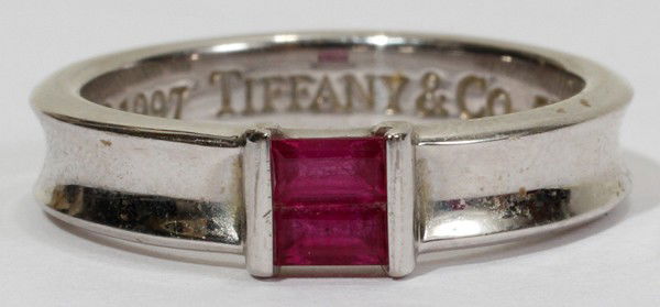 TIFFANY & CO. 18 KT WHITE GOLD & RUBY RING: TIFFANY & CO. 18 KT WHITE GOLD & RUBY RING:Tiffany stack ring is stamped "(copyright) 1997 Tiffany & Co. 750". Totaling approximately 5.7 grams. Includes Tiffany & Co. box (as is); size 7.