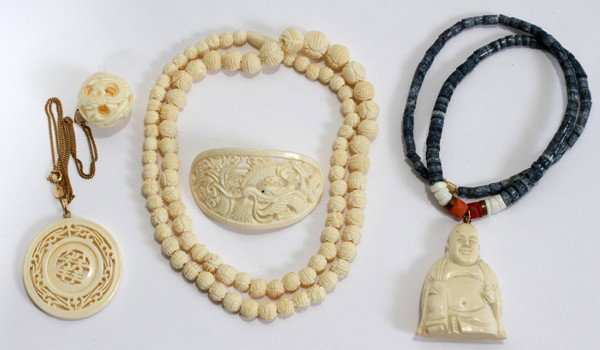CHINESE CARVED IVORY PENDANTS, NECKLACE, & : CHINESE CARVED IVORY PENDANTS, NECKLACE, & HAIR ACCESSORY, FIVE PIECES:Including 1 medallion form pendant and 1 mystery ball pendant both suspended from a single chain marked "AM Double", 1 ivory bead