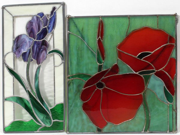 LEADED AND STAINED GLASS WINDOWS, TWO: LEADED AND STAINED GLASS WINDOWS, TWO:One window is H 17", L 8"and features a lilac flanked by clear and milk glass while the second is H 15 1/2", L 14" depicts red flowers flanked by green glass.