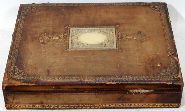 CHINESE WHITE JADE-INSET & LEATHER BOX: CHINESE WHITE JADE-INSET & LEATHER PRESENTATION BOX, LATE 19TH C., L 18":A rectangular box covered in brown tooled leather, the hinged cover is centered by a rectangular white jade panel carved with i