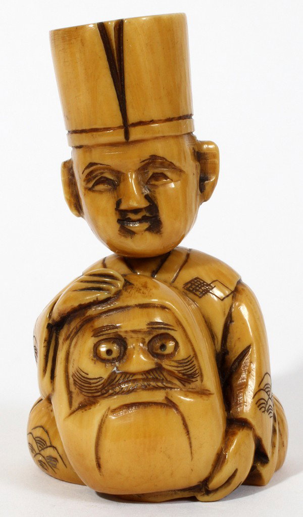 JAPANESE IVORY FIGURAL NODDING NETSUKE: JAPANESE IVORY FIGURAL NODDING NETSUKE:The figure is sitting with his legs crossed while he holds an object that resembles a mask. The netsuke has a signature on the underside. H. 2 1/4".